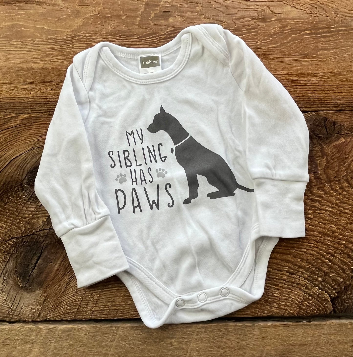 Kushies NB My Sibling has Paws Onesie